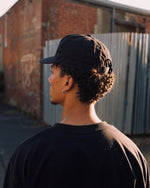 Cassowary Drive Short Brim Logo Hat — back view showing snapback closure