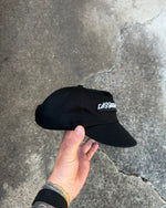 Cassowary Drive Short Brim Logo Hat — close-up of woven front logo