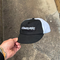 Cassowary Drive 2 Tone Short Brim Hat — front three quarter view showing raised embroidered logo patch